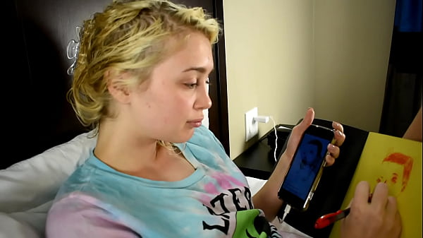 Cute Teen porn star drawing a picture while sitting on a bed before she gets used sexually