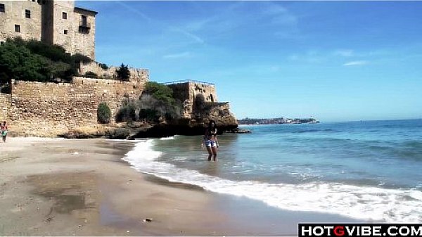 Slim Spanish Latina fucks herself on the beach