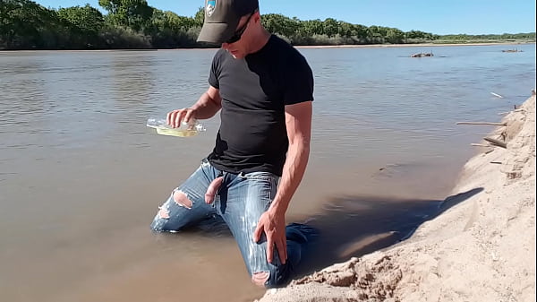Wetting jeans down by the river  