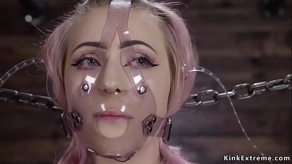 Alt blonde chained in standing position in extreme device bondage with plastic mask on her face then bent over gets ass whipped by master The Pope 
