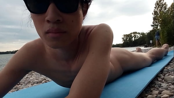 This cute Asian twink is nude for the first time on this French nudist beach, guys stare at him, go near him, think to put their dick in his little ass hole 