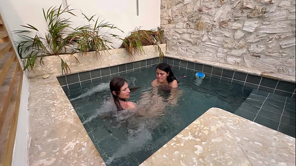 Two hot lesbians masturbate in a public pool, afraid of getting caught.  