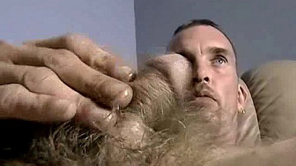 Horny amateur hunk tugging on his hard hairy cock 