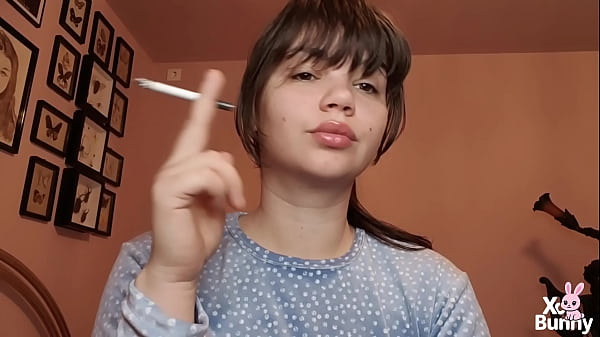 Brunette with natural big lips with natural color lipgloss smoking a cigarette blowing smoke in your face  