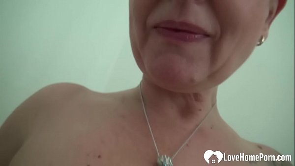 Mature chick spreads her legs and penetrates herself while she moans in pleasure.