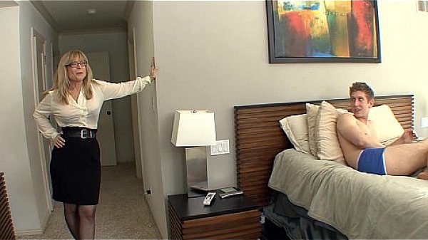 Busty cougar seduces in stockings and a garter