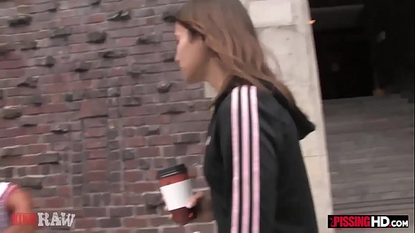 Slim brunette gets pissed on by two guys and sucks their dicks 