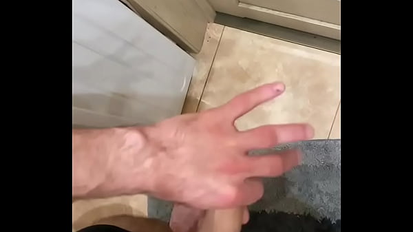 the guy jerks in the toilet and cums at the door  