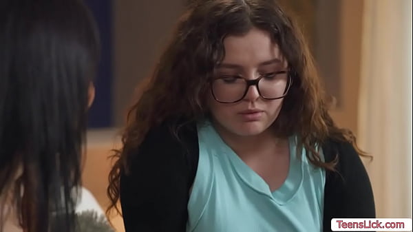 Chubby nerd and her brunette stepsister are on the bed kissing each other passionately