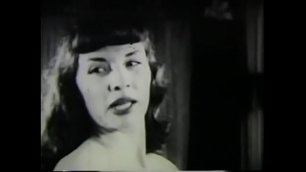 Hottie with bangs stripping on camera in vintage film 50s