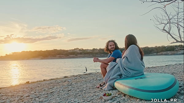 Real couple having beautiful romantic sex at the shore of a lake