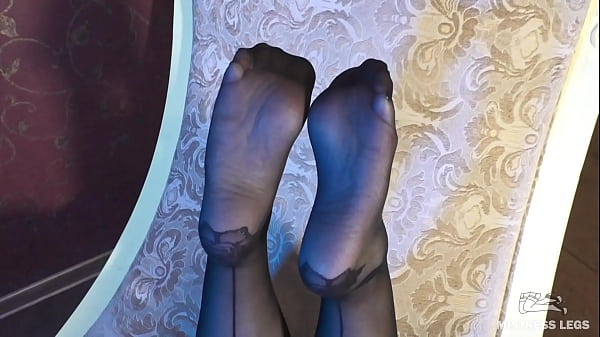 Enjoy my feet in sexy black nylons with flower prints on my heels