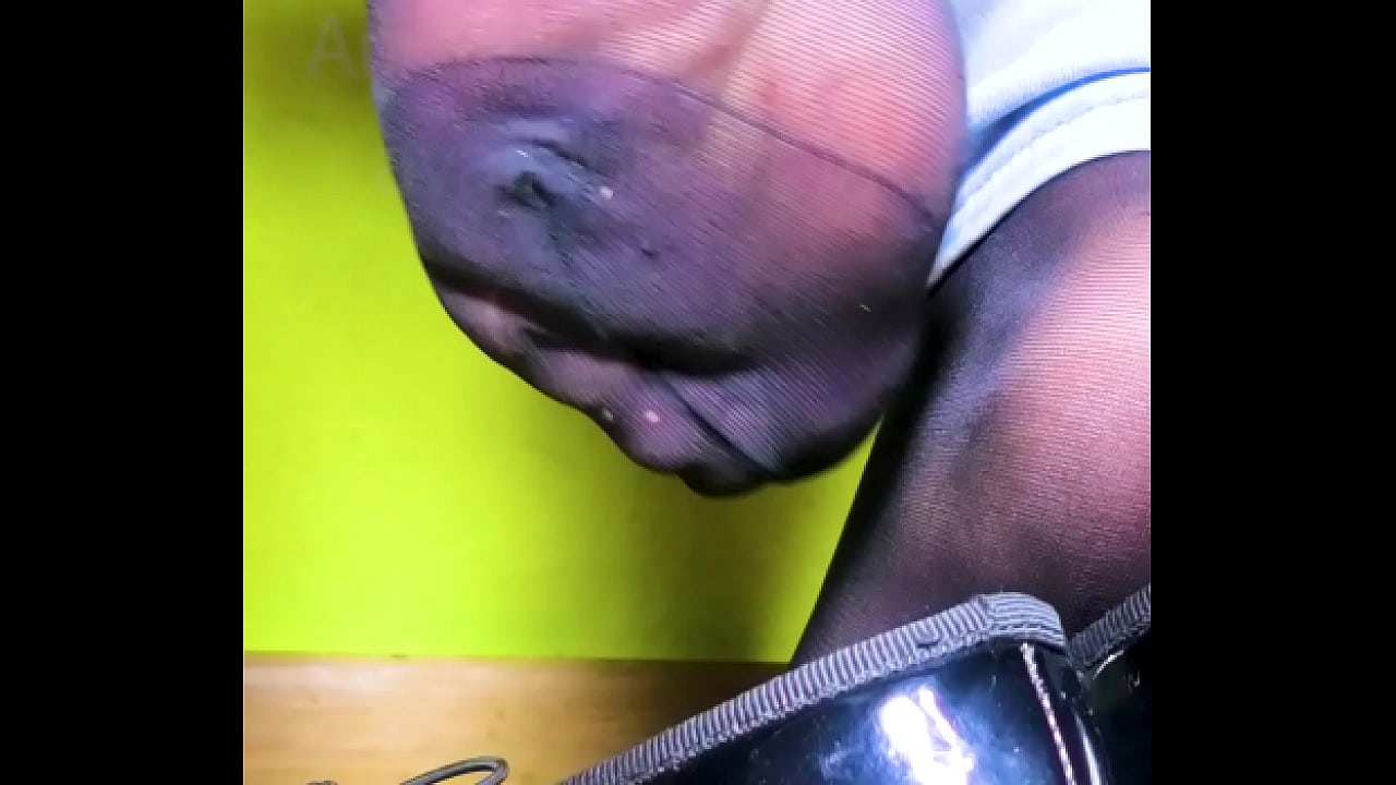 Young black-haired girl shoeplay dipping lack lacquer black flats shoes and her stinky nylon