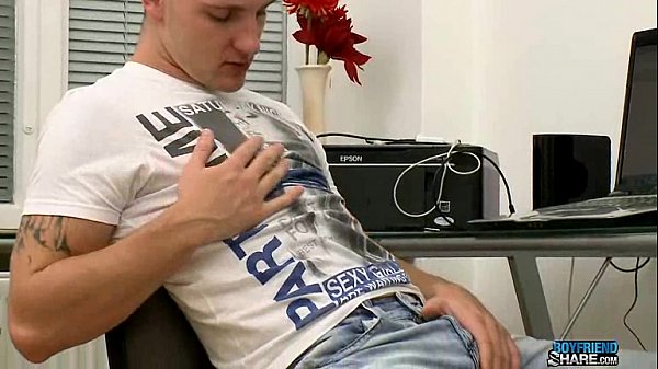 Inked jock jerking off in office