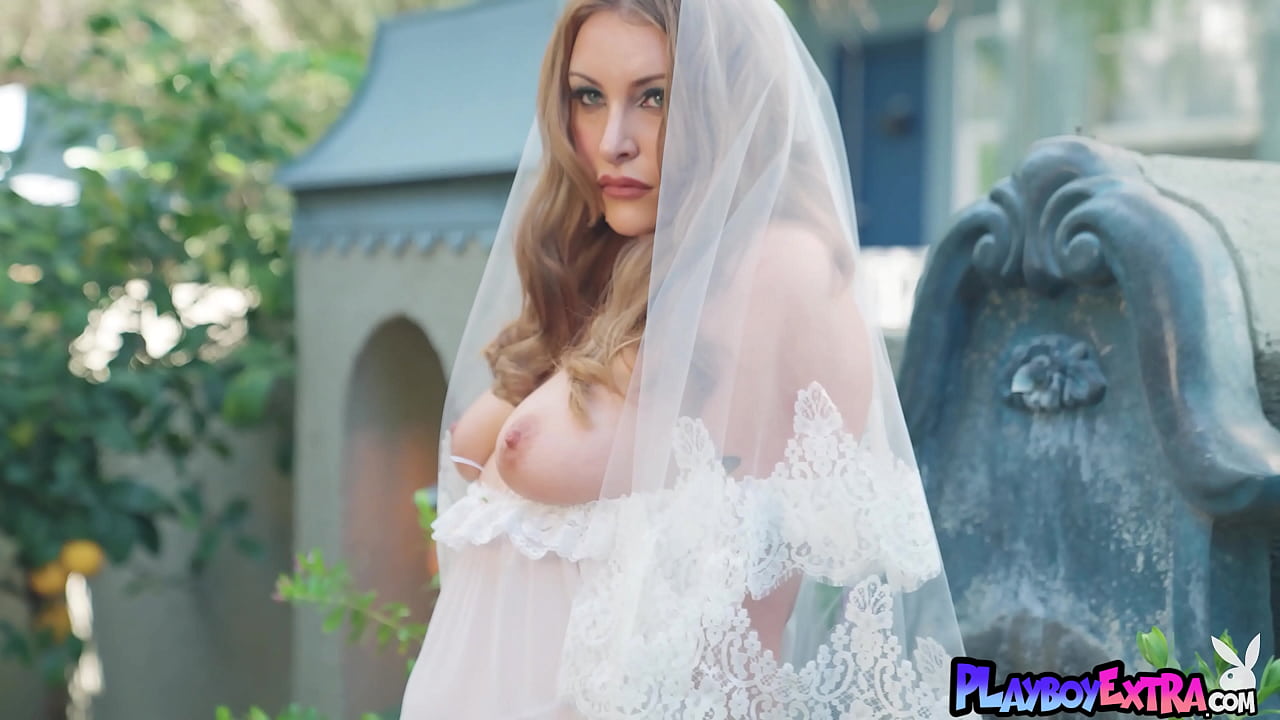 Passionate red cougar taking off her wedding dress outdoor