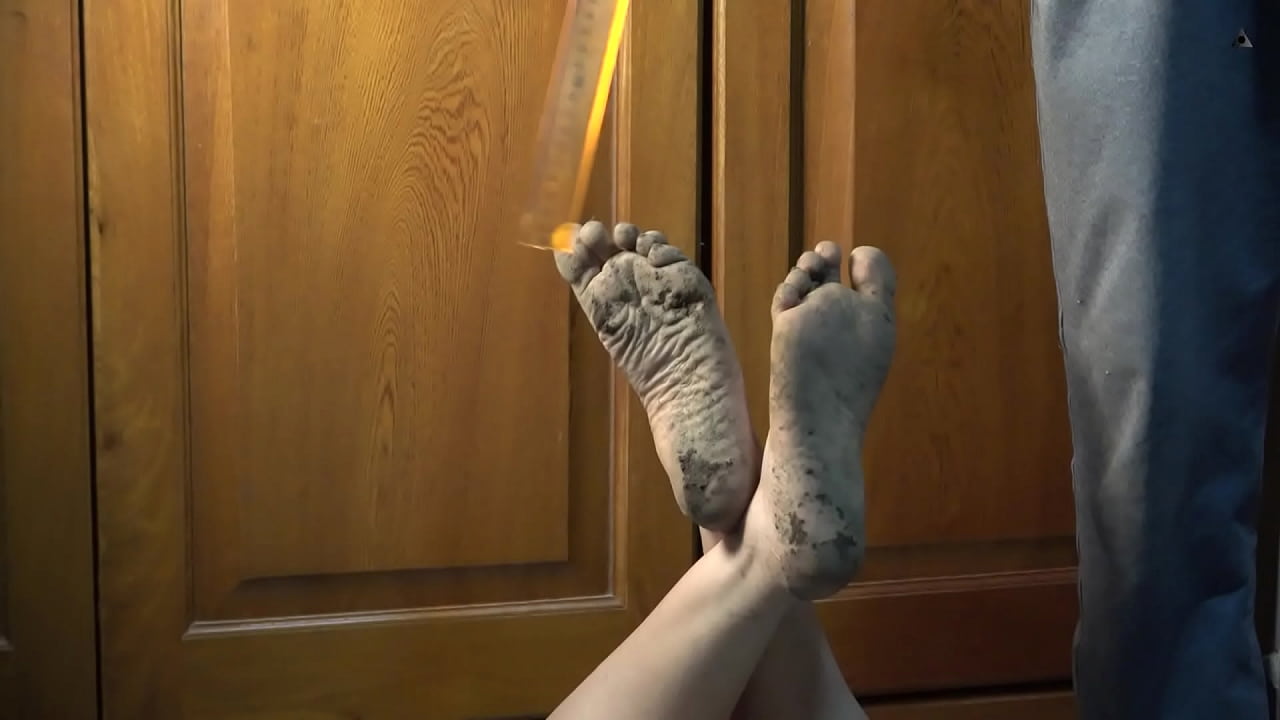 For foot fetish lovers, feet dirty with dirt. Bugs Bunny pose. hits with a rule in a sole of foot