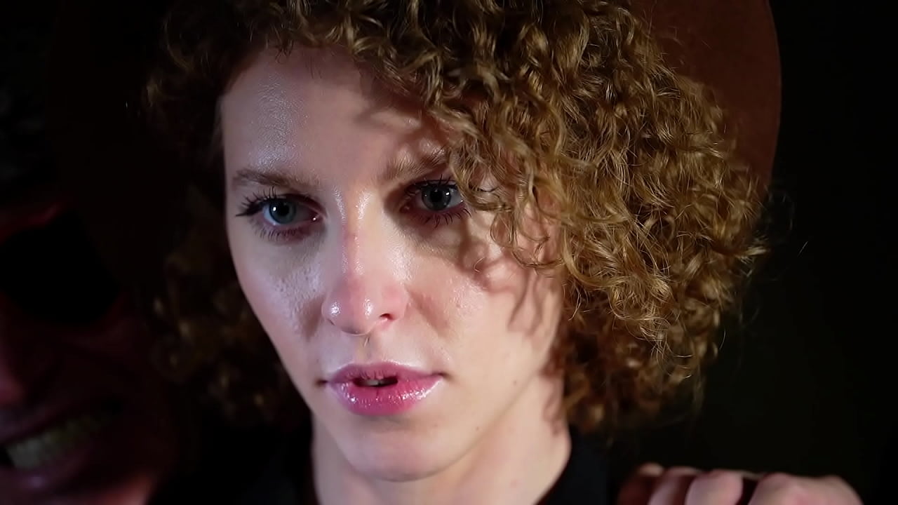 Red curly hair in the hands of a voluptuary