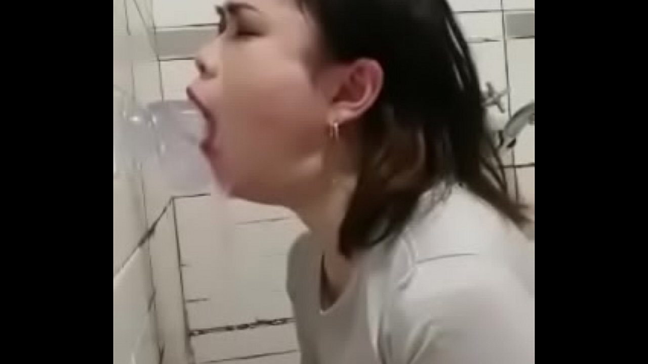 Asian girl face fucking herself with a dildo