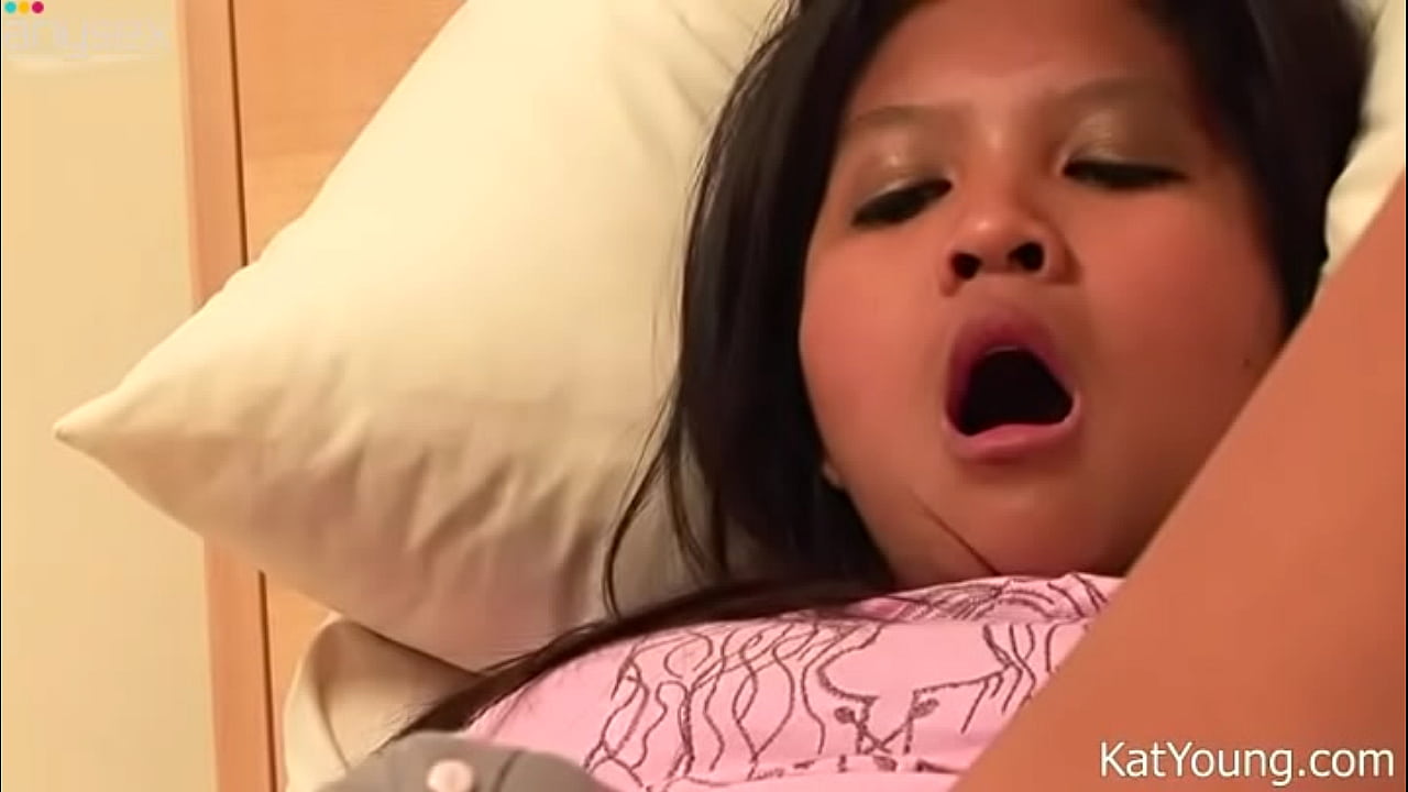 Lusty Asian teen Kat Young plays with her tight pussy in bed
