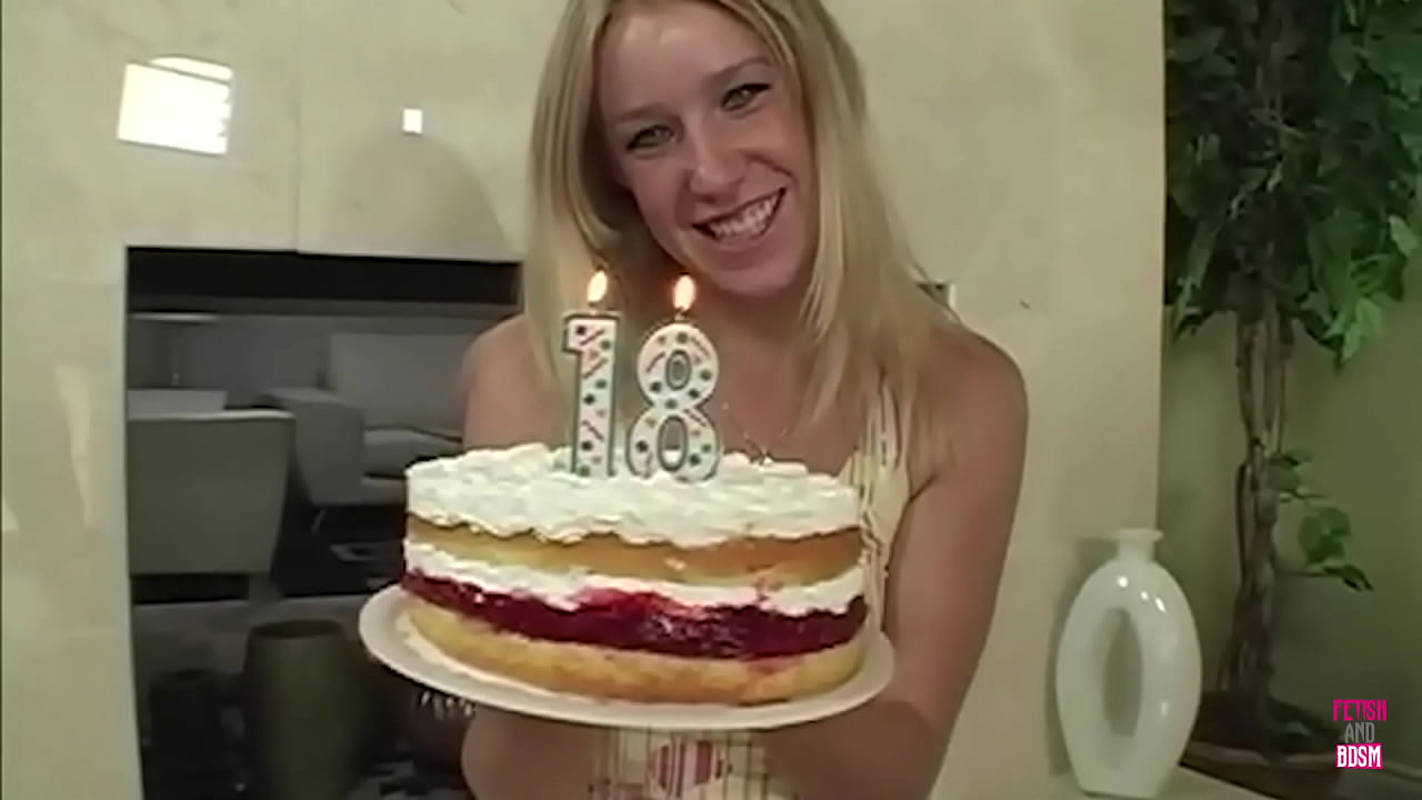 A stunning blonde woman, adorned with a birthday gift, delivers an exceptional blowjob to her partner