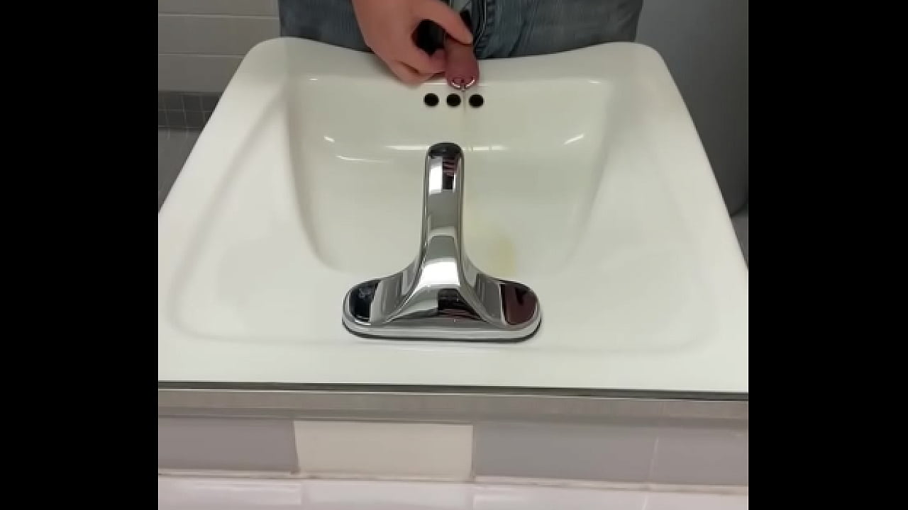 Me pissing through a penis plug in the mirror after partying at the office