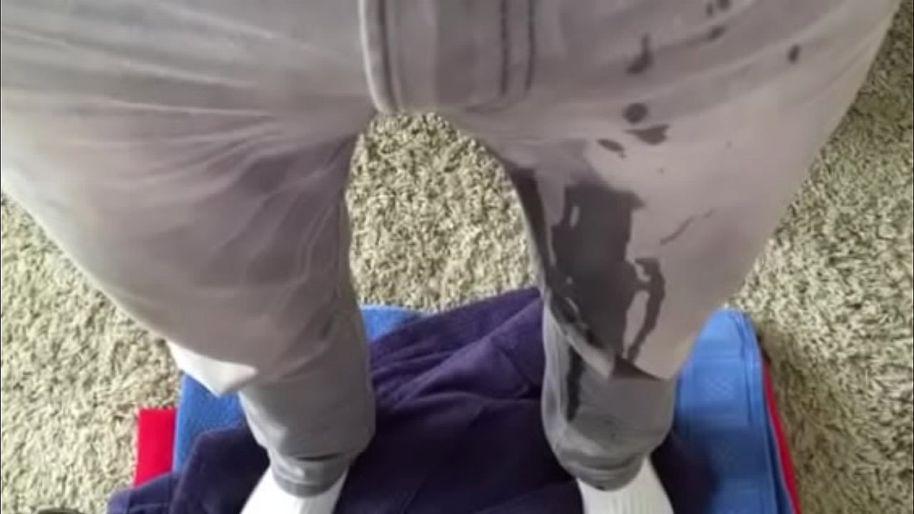 guy wetting his grey jeans