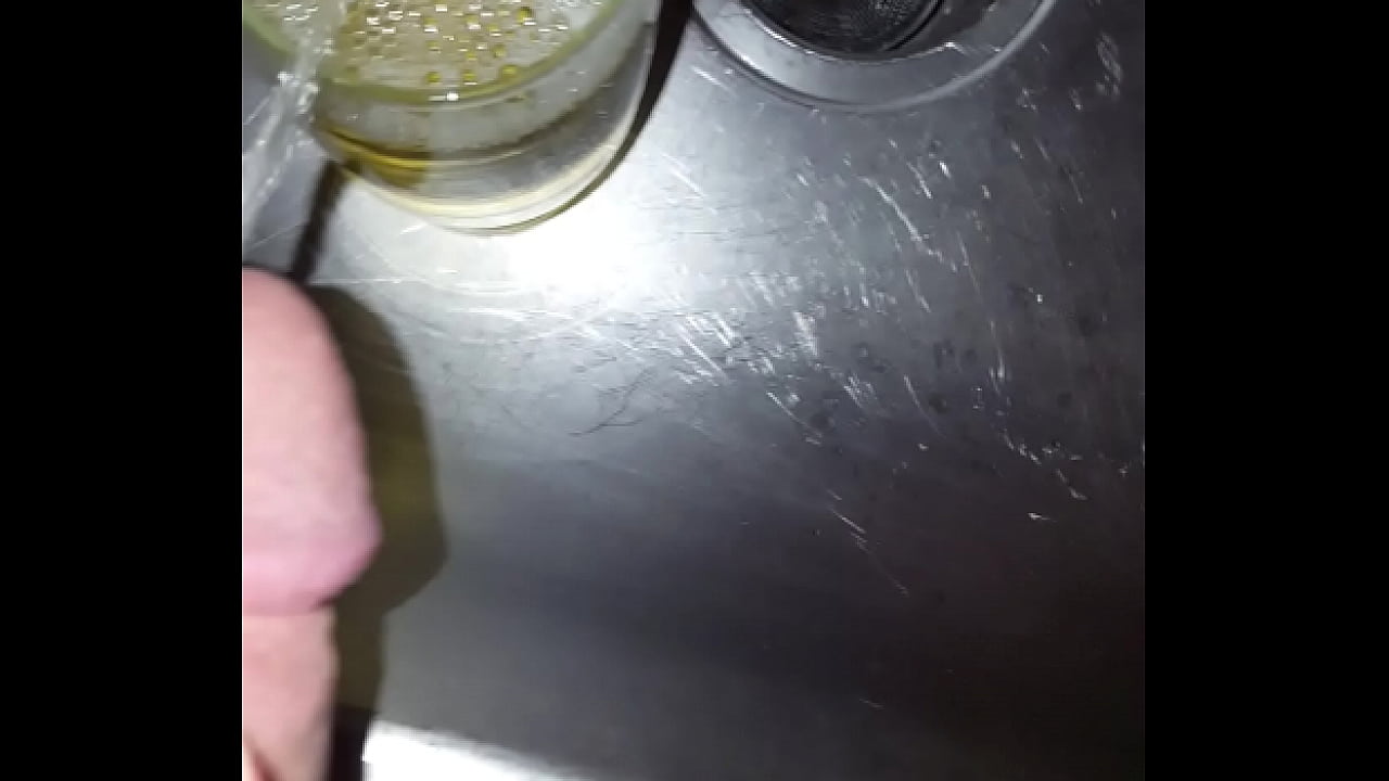 Strong golden piss into a cup