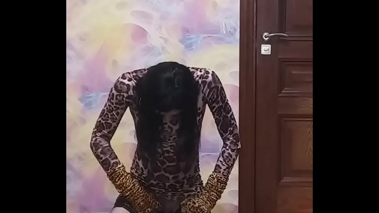 Crossdresser in long leopard dress with vibrating plug pees in glass and drinks