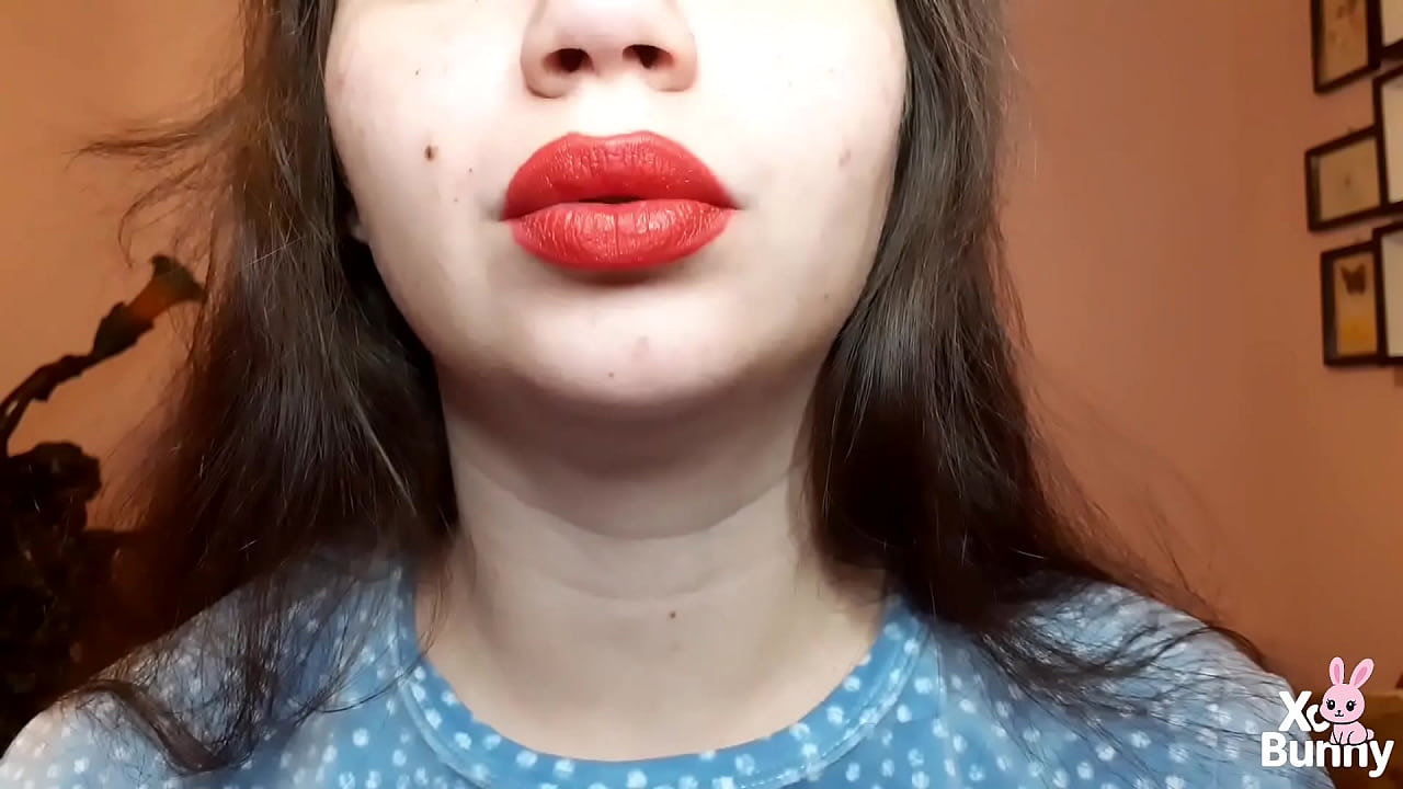 Natural lips with red lipstick smoking a cigarette in close up