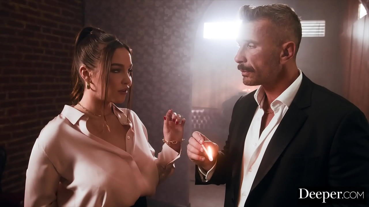 A cigar shop employee is at the service of an exacting customer.