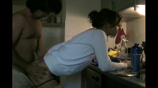 Couple having sex in kitchen