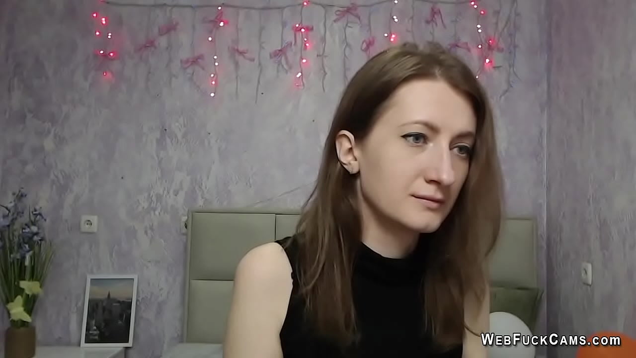 Brunette amateur babe KlaraDreval in sleeveless top strips of and shows boobs in black bra while chatting with strangers in live webcam show solo