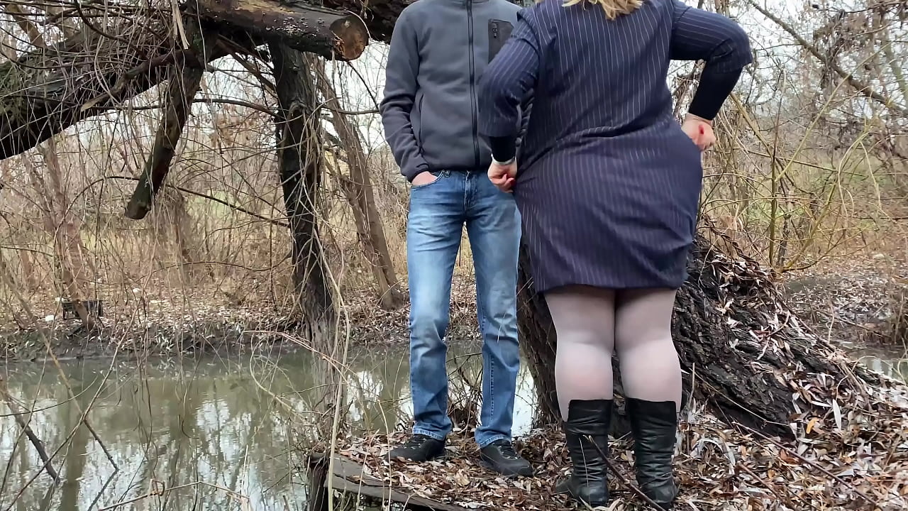 Sexy mother-in-law pissing outdoors with her legs spread wide and bent over