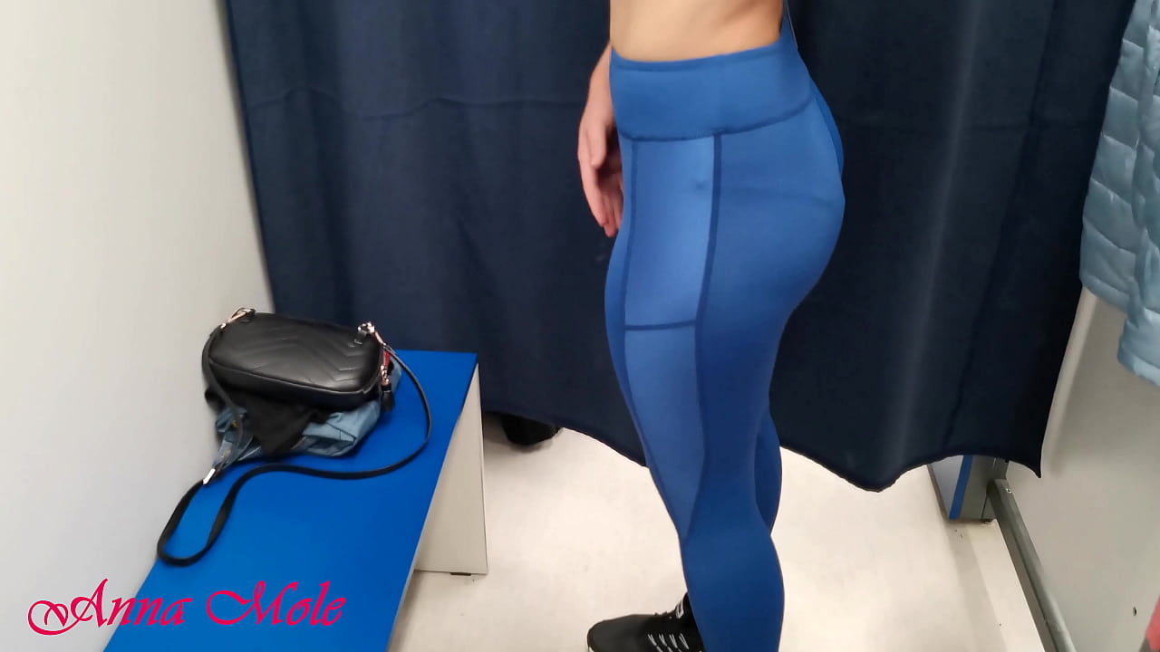 In the dressing room, a student tries on various pants for sports. Anna Mole