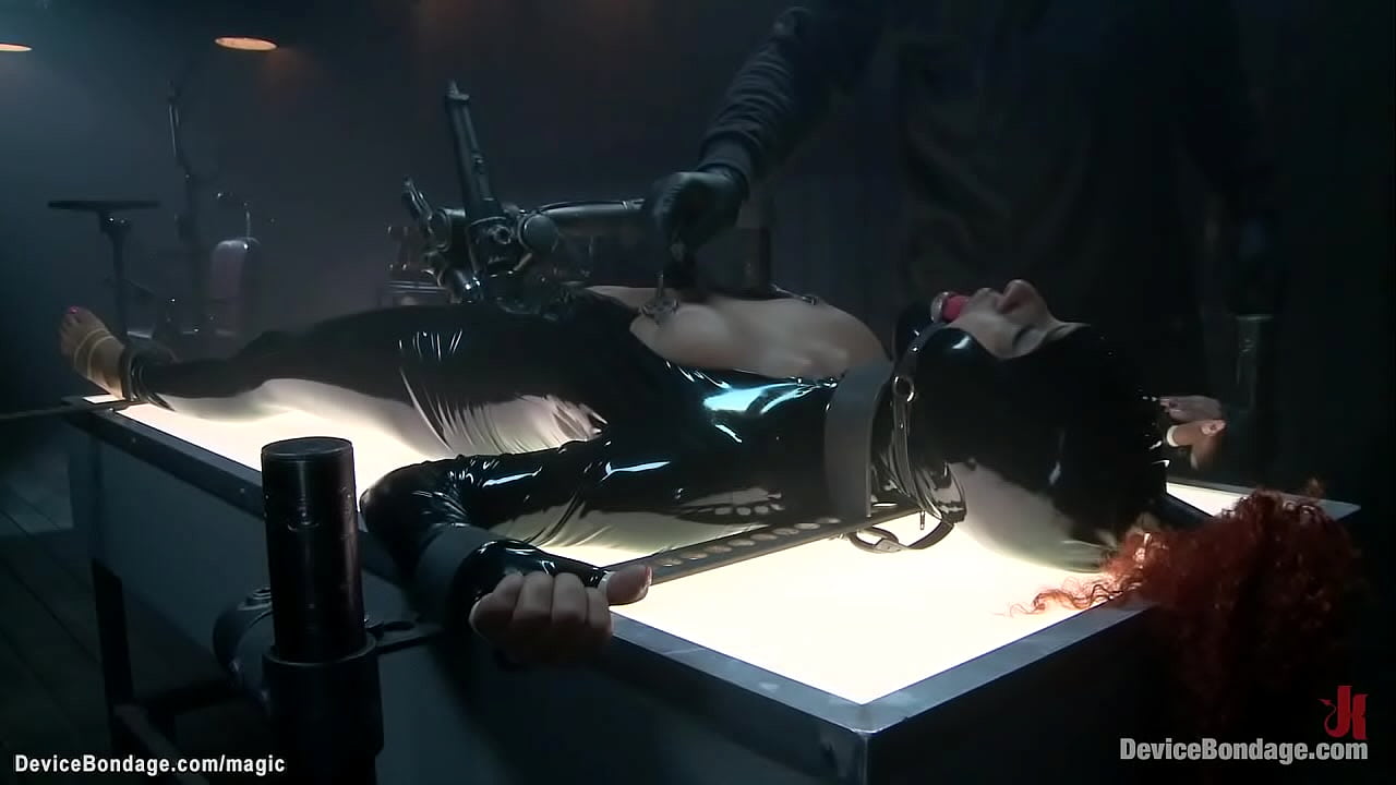 Gagged redhead ebony slave in latex suit Daisy Ducati gets nipples tormented with spur then in metal device bondage ass hooked and fingered