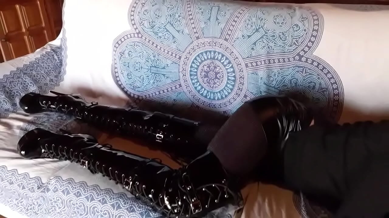 Total black with fishnets pantyhose and boots over the knee