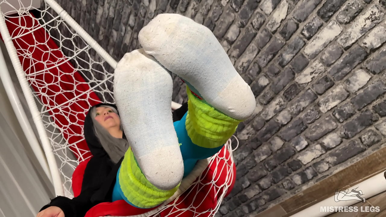 Long sexy legsand feet in blue nylons swings in a hanging chair above you