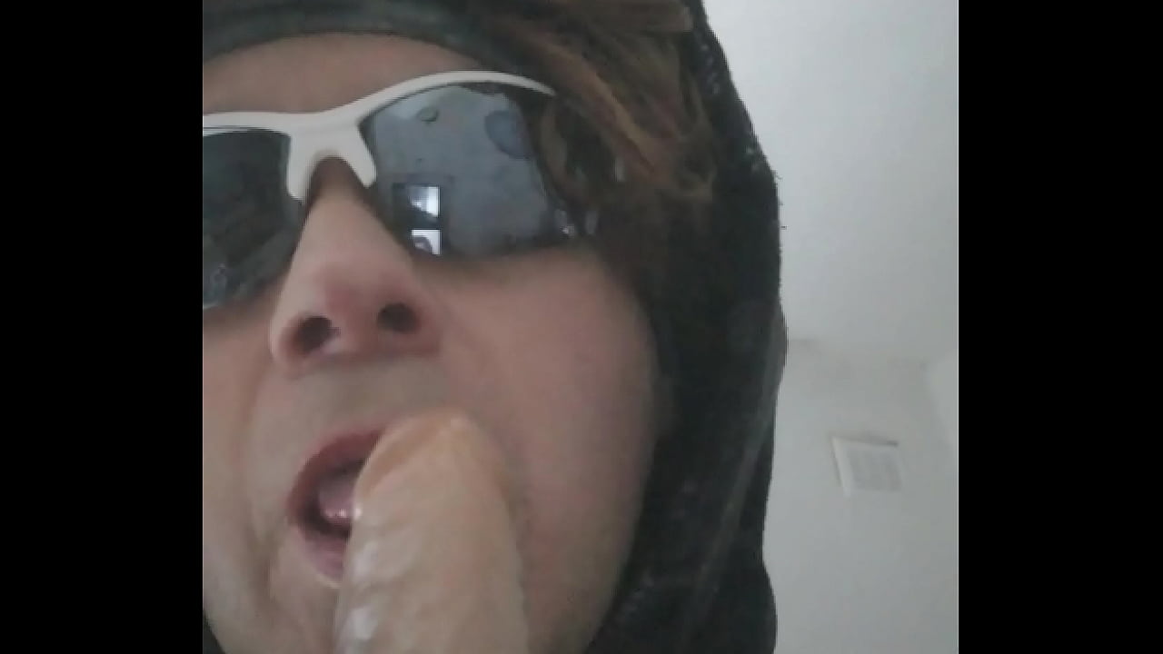 Gagging on a rubber cock, makeup and wig