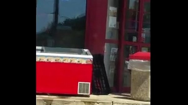 Gas Station Employee cleaning a cooler