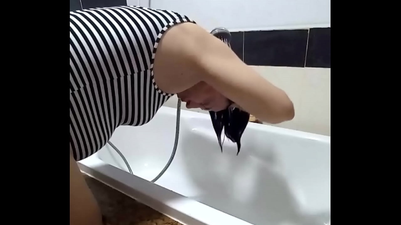 Shower. Voyeur camera. Nude Regina Noir in the shower washes her hair.