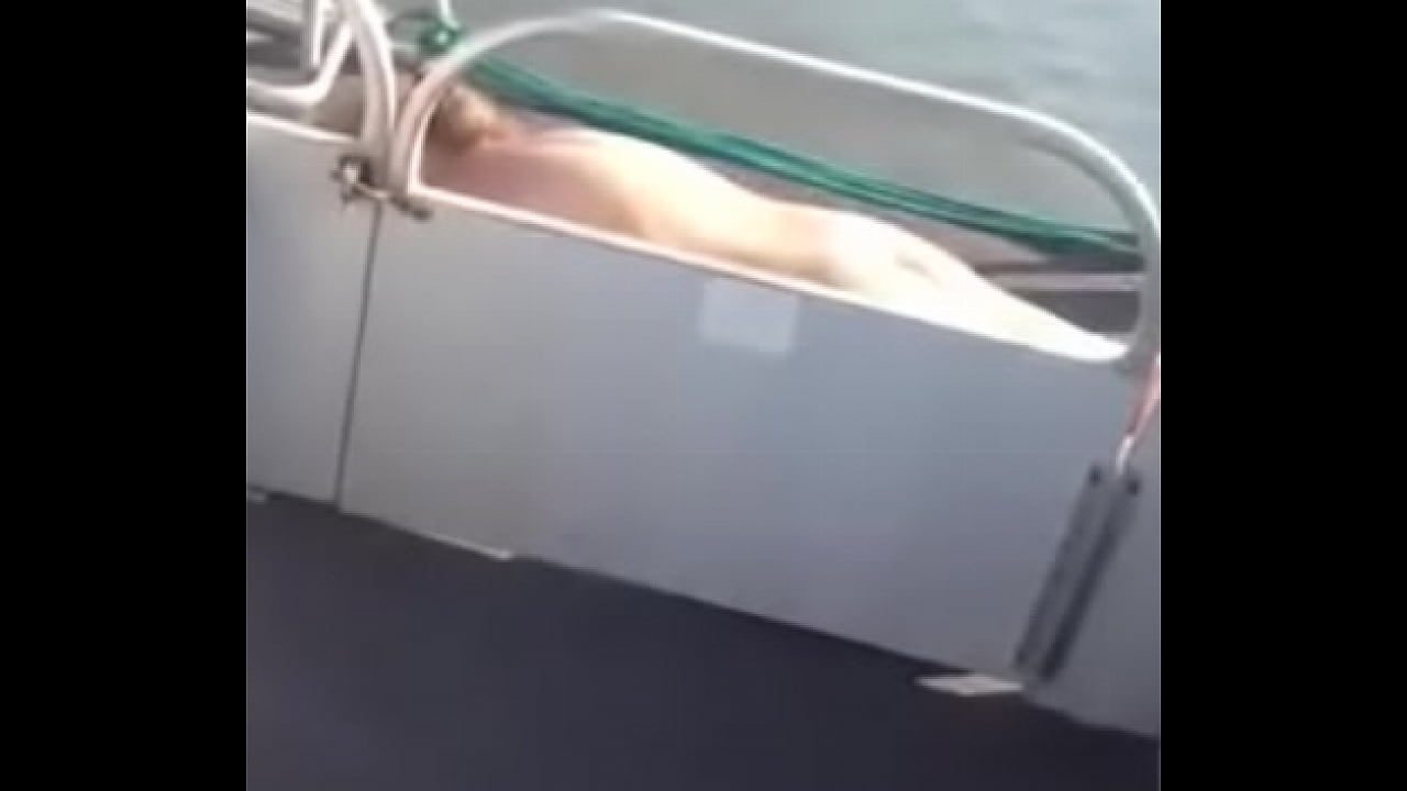 blonde MILF sun bathing Naked on pontoon boat