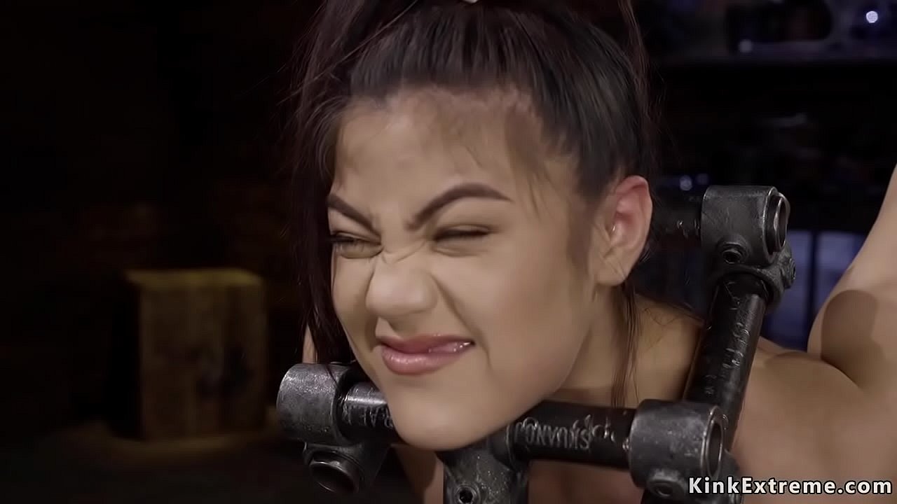 Hot petite brunette slave Kendra Spade standing on pins surface while her head and hands are in wooden boxes suffering pain then master toying her in dungeon