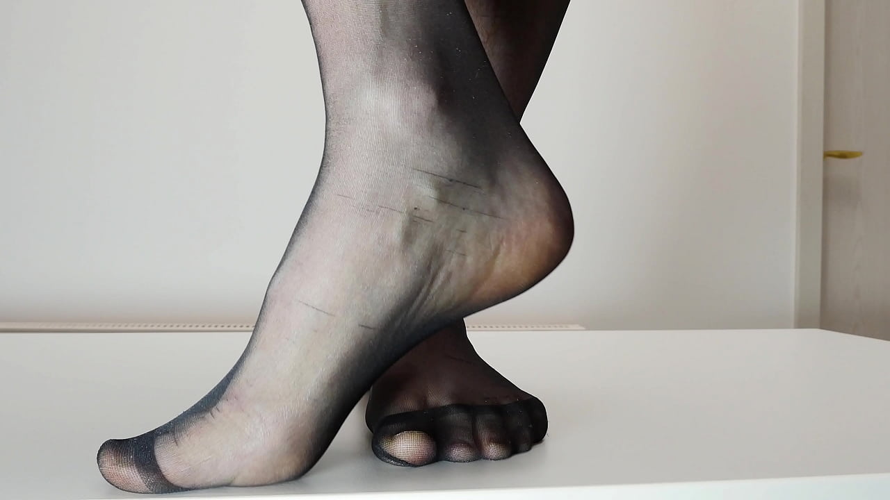Feet in black nylon stockings