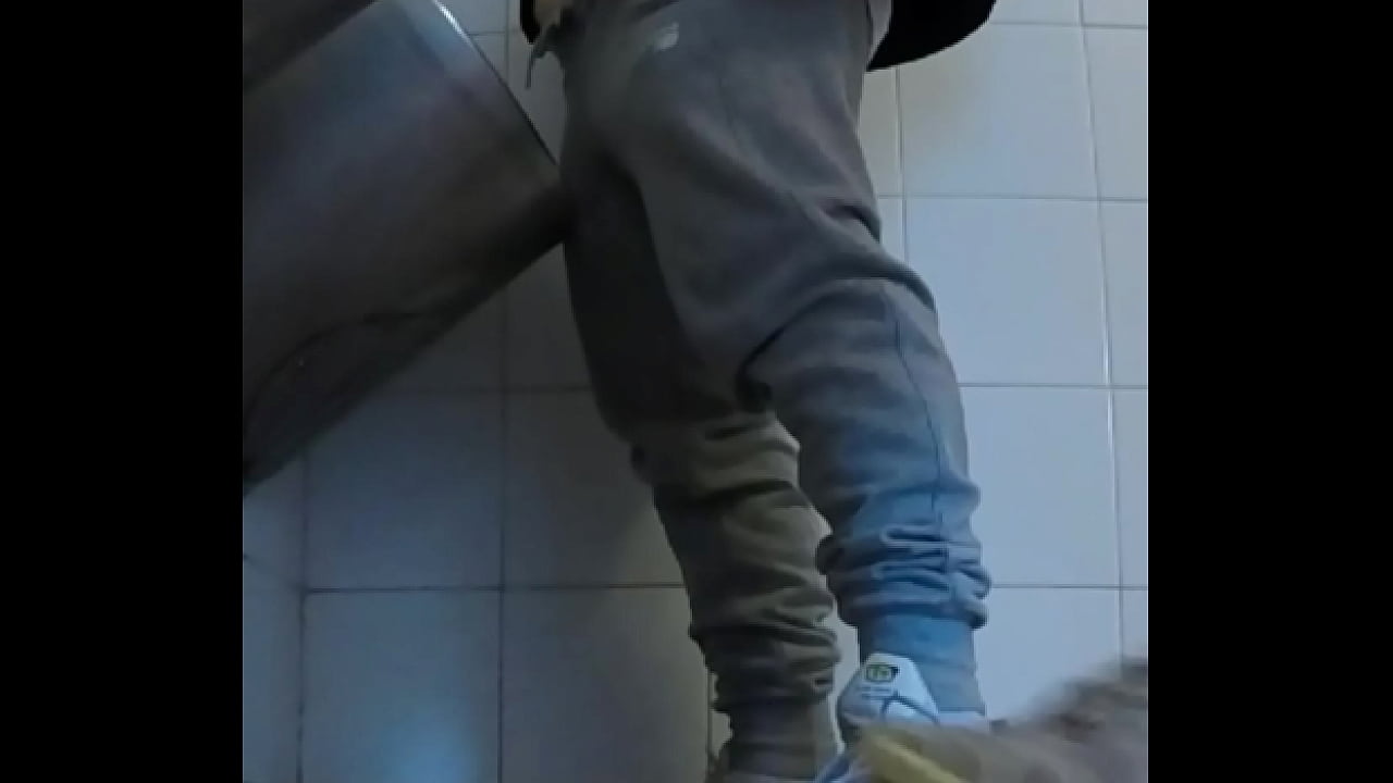 Amateur boys in sneakers wank and try handjob in public toilets' urinal