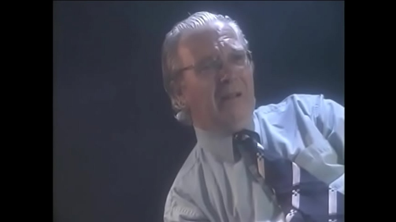 Two lesbians bring each other to orgasm with the help of toys while a man in a chair watches them