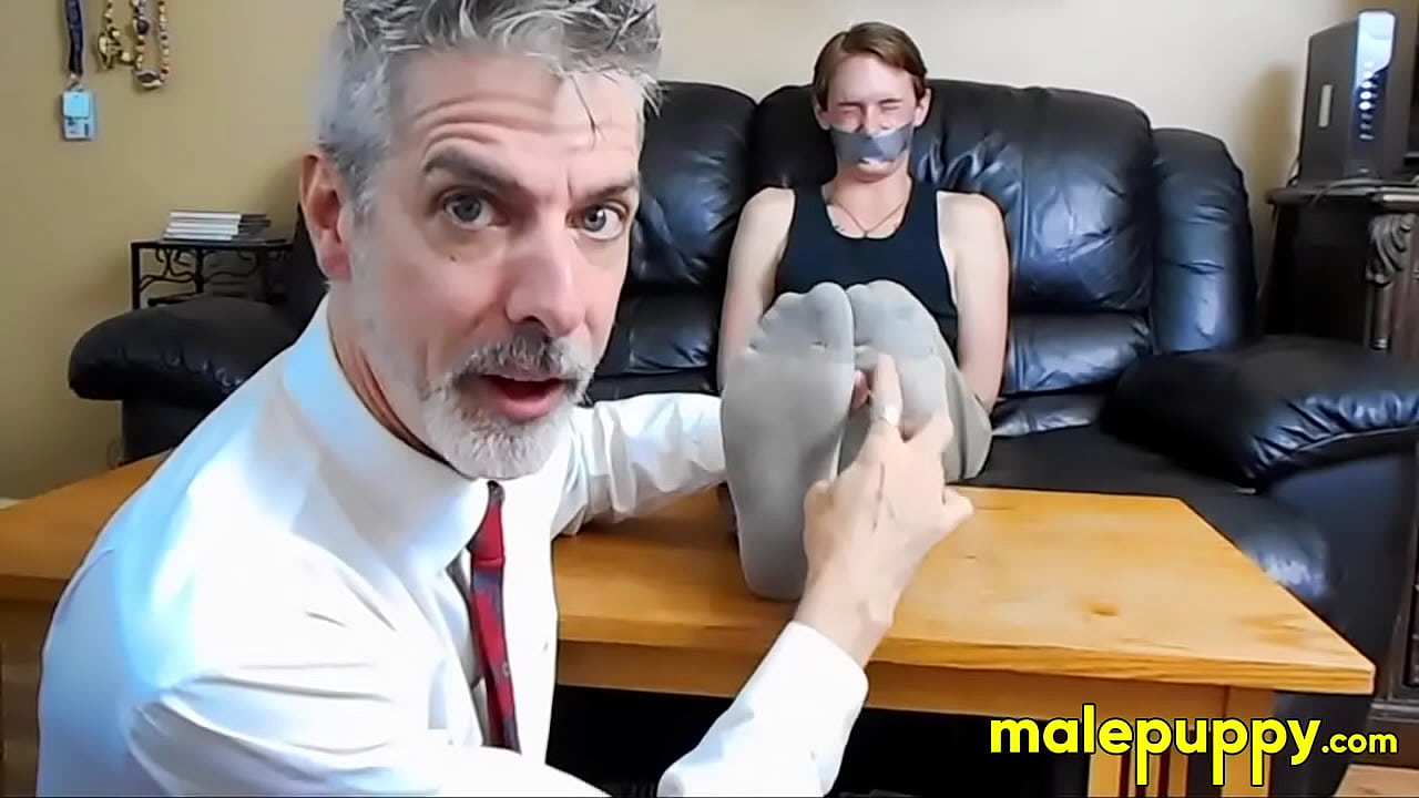 Professor Richard Lennox has found a freshman student "volunteer" to illustrate his theories about tickling human male feet.