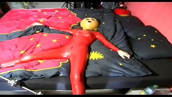 A girl dressed in red latex has a real sinister mask