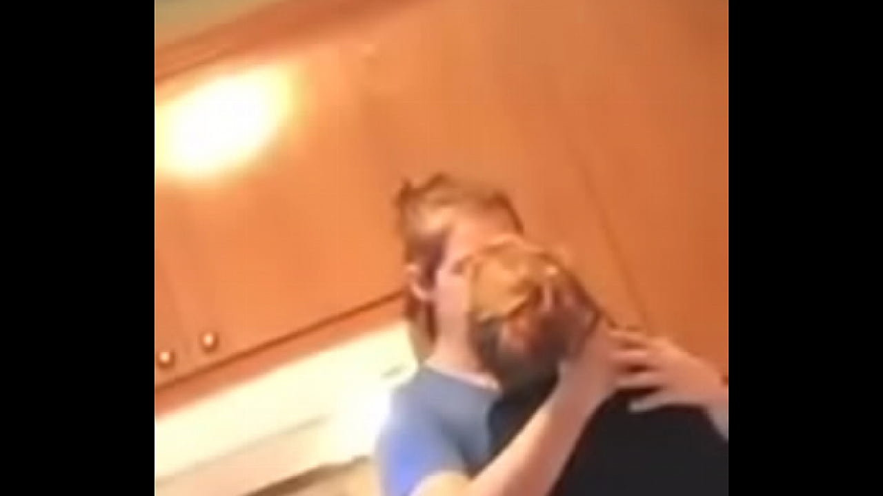 Lesbians kissing while their friend sees