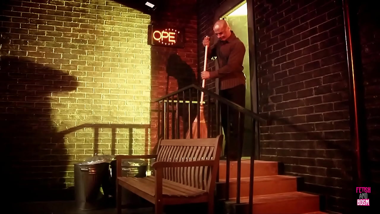 A man encounters a mischievous dark-haired woman wearing a cat-themed mask, who is about to have a facial treatment