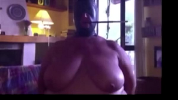 Augusta- A slut wife is chairbound, hooded, smoking with a long holder, then gagged and fucked